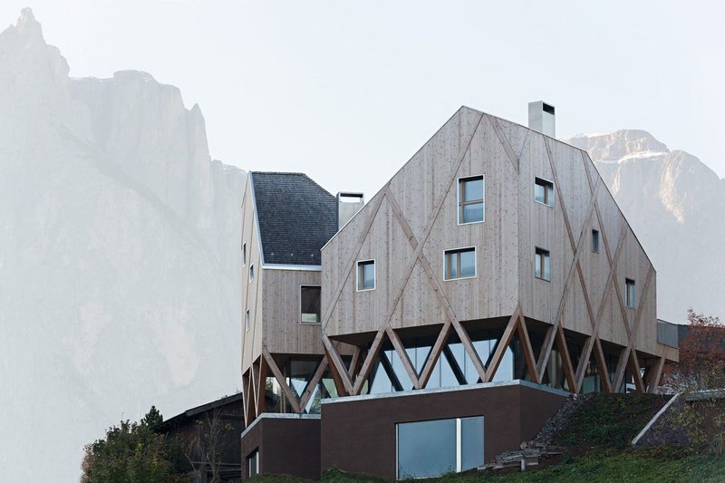 Villa Kostner has a work space beneath one of the timber volumes.