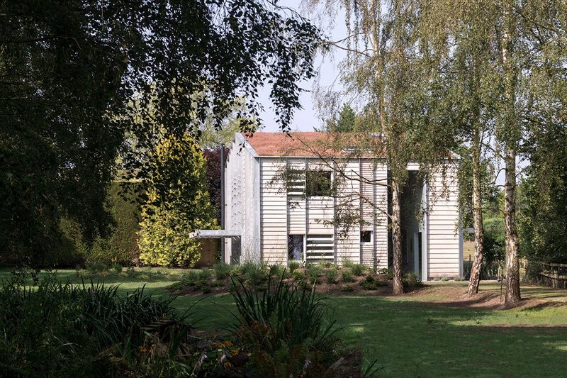 Larch-clad Old Shed New House featuring Velfac windows: the former agricultural container in North Yorkshire now houses a collection of books and art. Tonkin Liu architects.