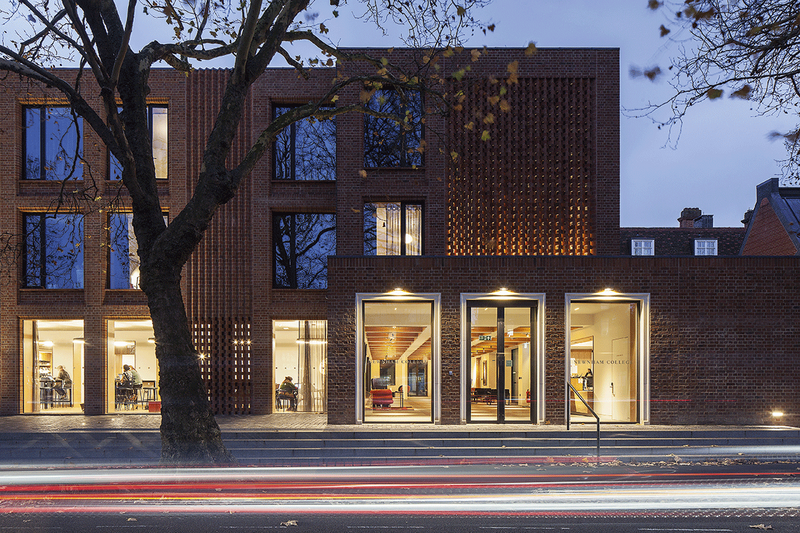 The Sidgwick Avenue elevation of the Dorothy Garrod Building with its illuminated hit and miss brickwork creating an understated, elegant entrance.