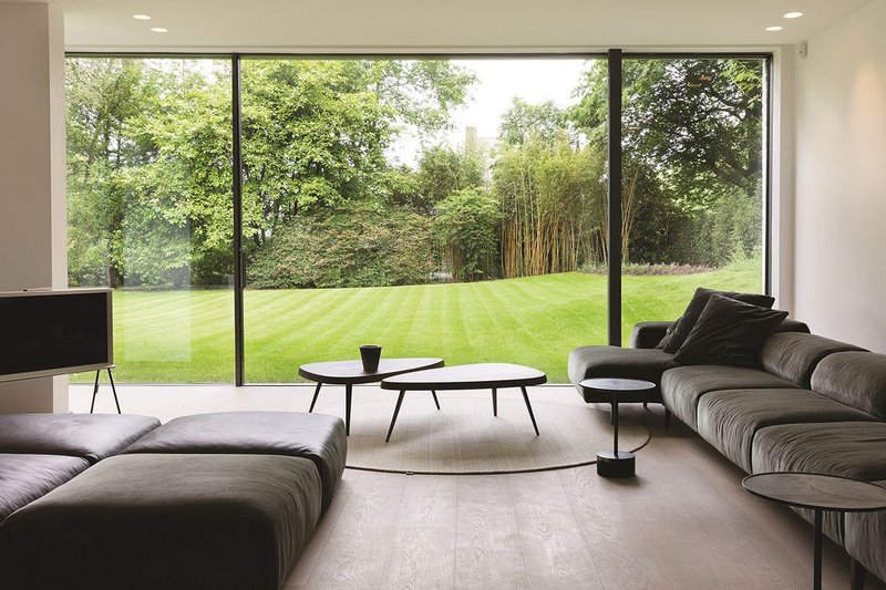 Floor to ceiling glazing from Reynaers at a house designed by Atelier d'Architecture Bruno Erpicum in Belgium.