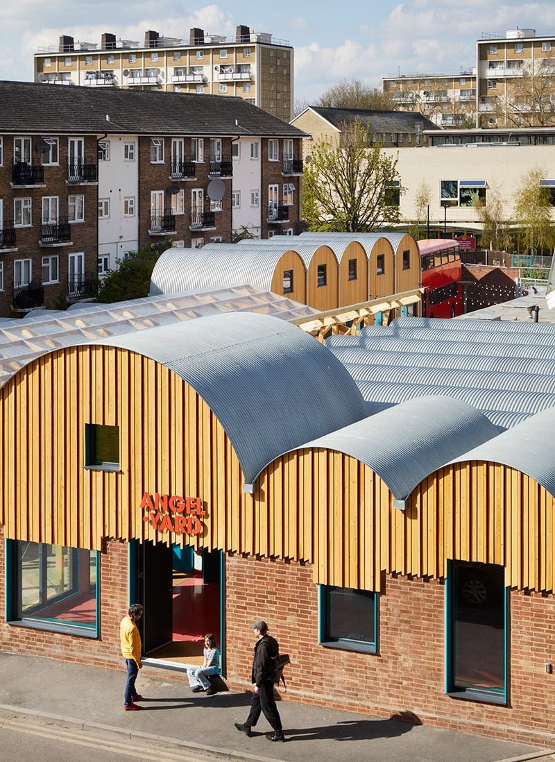 The former garage forecourt is now a community hub, engaging with the street on the south side.