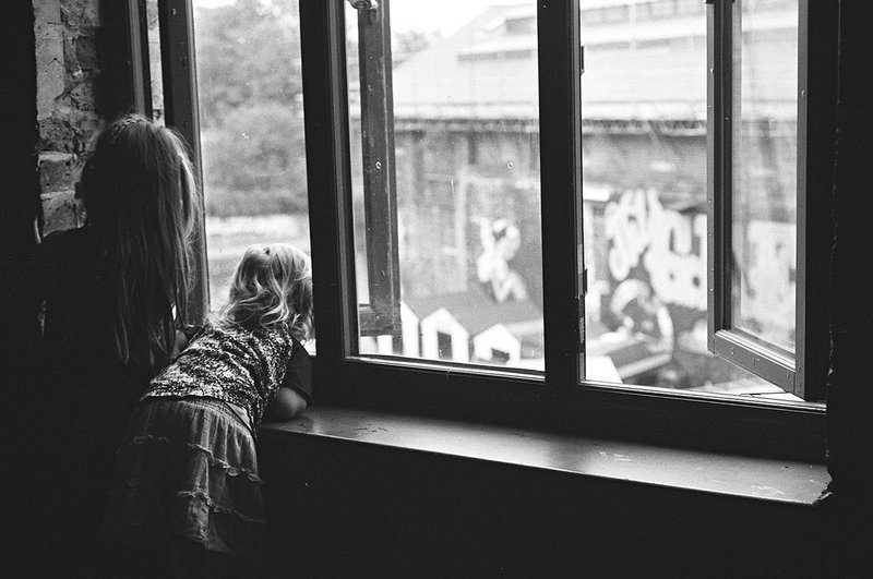 Children leaning out of window.