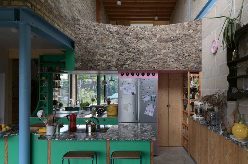 Cork tiles form a distinctive and tactile balustrade in AOC’s Forest House kitchen, inspired by nearby Epping Forest.