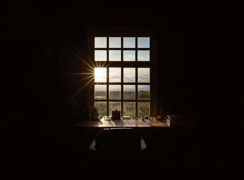 Derek Jarman’s writing desk in the Spring Room at Prospect Cottage as the sun rises on 17 May 2021.