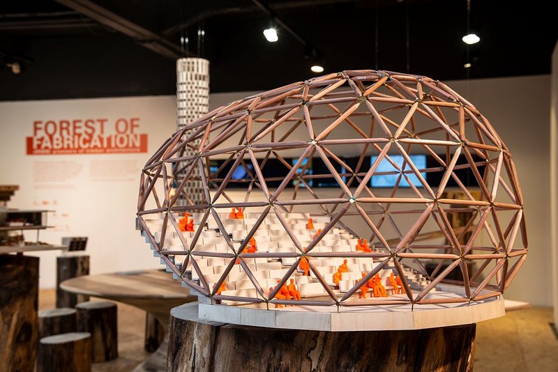 The 300-seat auditorium superstructure comprises a geodesic shell made from 150mm diameter larch poles with bespoke aluminium and steel nodes. Forest of Fabrication exhibition, The Building Centre, London.