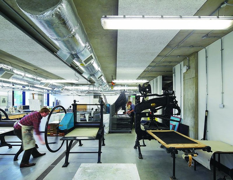 Workshops hold the historic machinery of an arts and crafts school of art, here printing presses. In the central spaces though laptops abound.