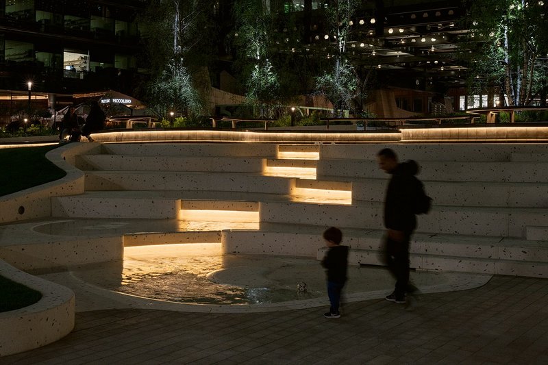Indirect lighting highlights the rippling water within the auditorium cascade feature.