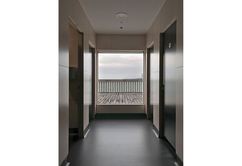 Seven gender-free toilet spaces are indulged with wide access windows and large picture windows to the sea beyond.