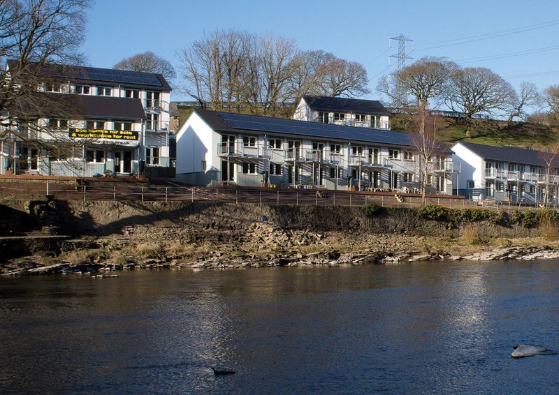 The Co-Housing development takes full advantage of its riverside location, with shared green spaces running down to the river bank.