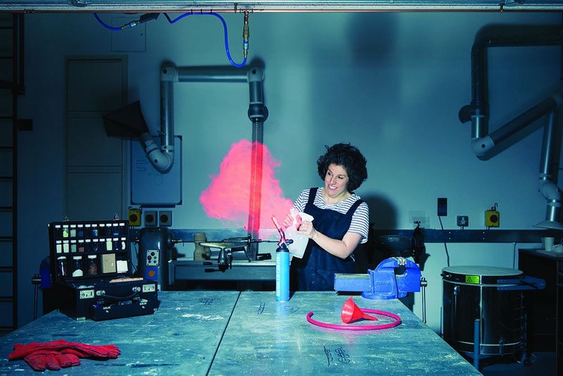 Making flames:  Zoe Laughlin introduces strontium chloride in methanol to a blowtorch.