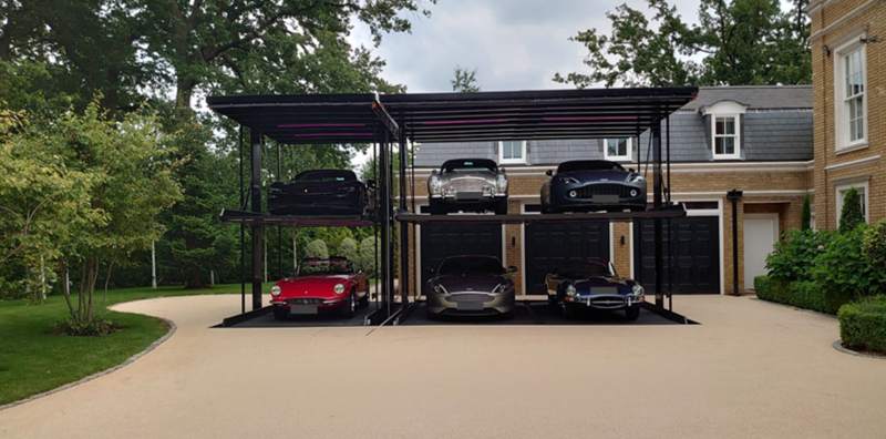 Wohr Parklift 462 system at the Surrey house: the platforms lower into a pit below ground so the gravelled canopies lie flush with the drive.