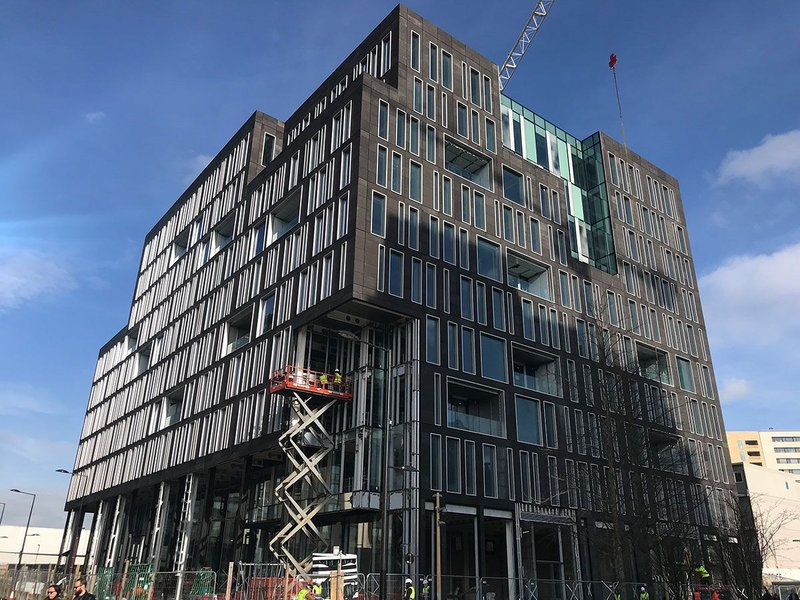 Google DeepMind at King’s Cross, London, with its deepset balconies and white window reveals to bounce light into the space.