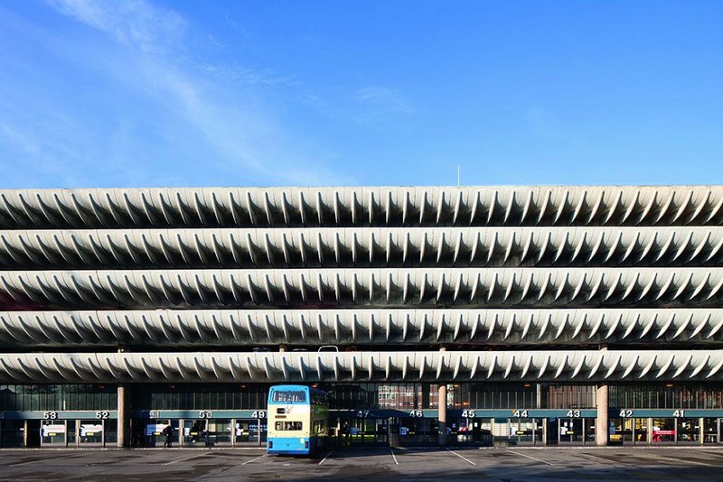 The curved edges to the car park levels are perched above the bus station concourse.