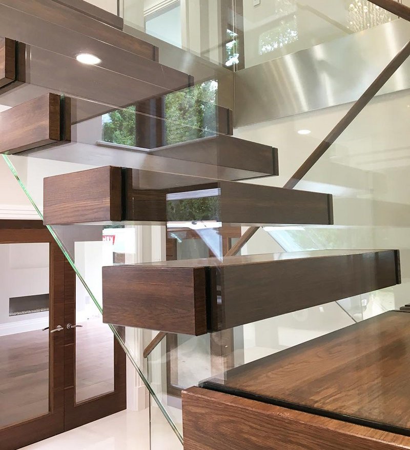 Canal Engineering's latest cantilever staircase with walnut treads and a glass balustrade.