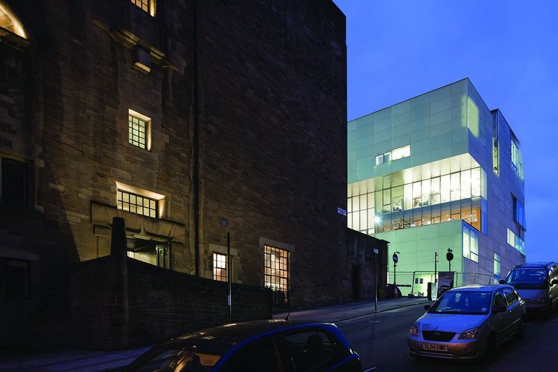 The bright facade of the Reid Building may look like an interloper by day but at night it glows, a lantern perched uphill of Mackintosh’s Glasgow School of Art.