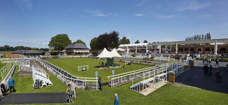 The project has been developed in two stages around the parade ring in the foreground, phase 1 (left) and phase 2 (right) .