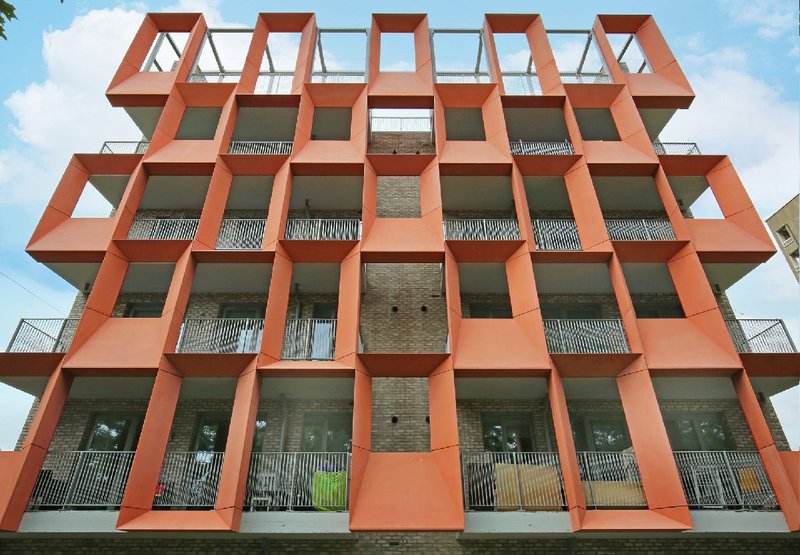 Orwell House on the Dorset Estate, Bethnal Green with loggia at either end screened by pink GRC panels.