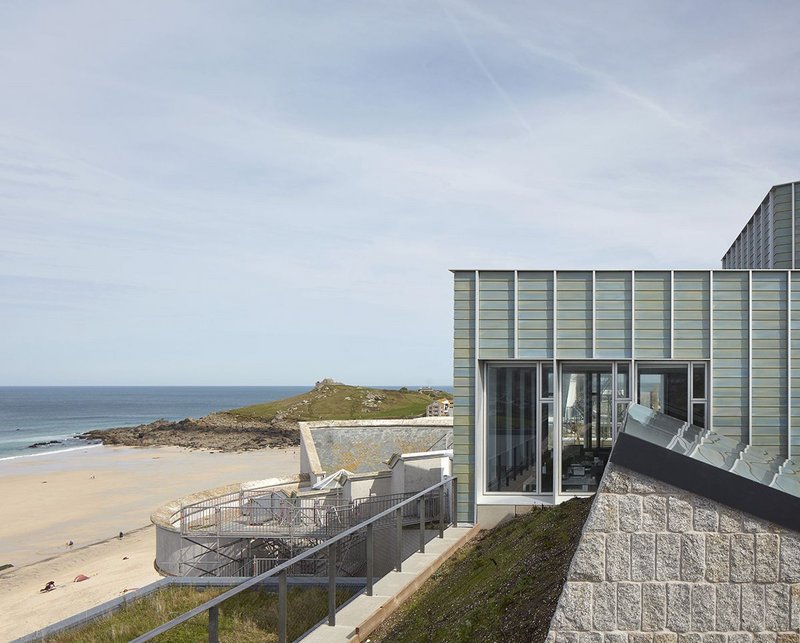 The new upper storey of Tate St Ives has emerged above Porthmeor Beach after a decade of wrangling.