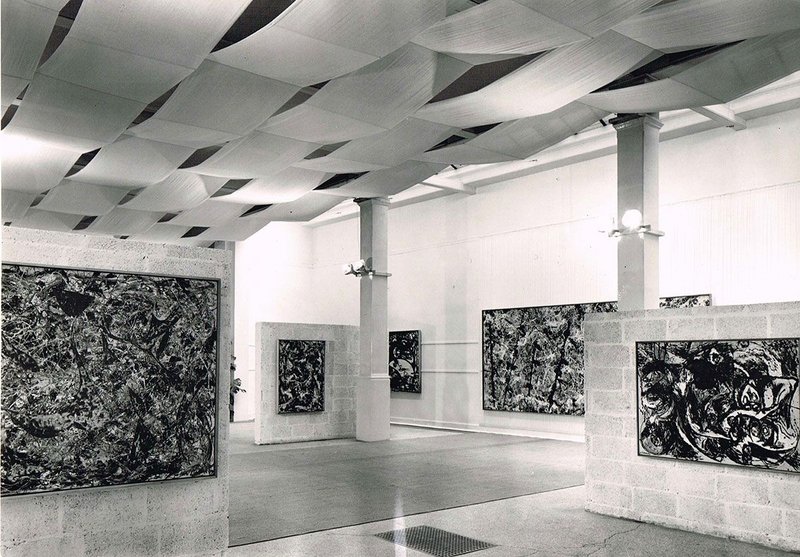 Installation view of Jackson Pollock exhibition 1958, designed by Trevor Dannatt at the Whitechapel Gallery. © Whitechapel Gallery. The installation featured an assemblage of breezeblock walls, fabric canopy and carpet to create a space within a space.