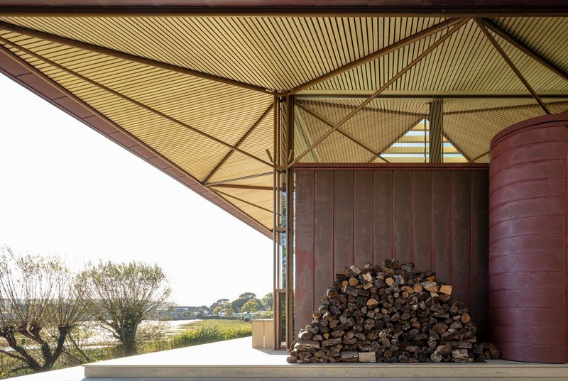 The copper-clad cylinder at Niall McLaughlin Architects’s Saltmarsh House houses the hydraulic interface with the remote air source heat pump.