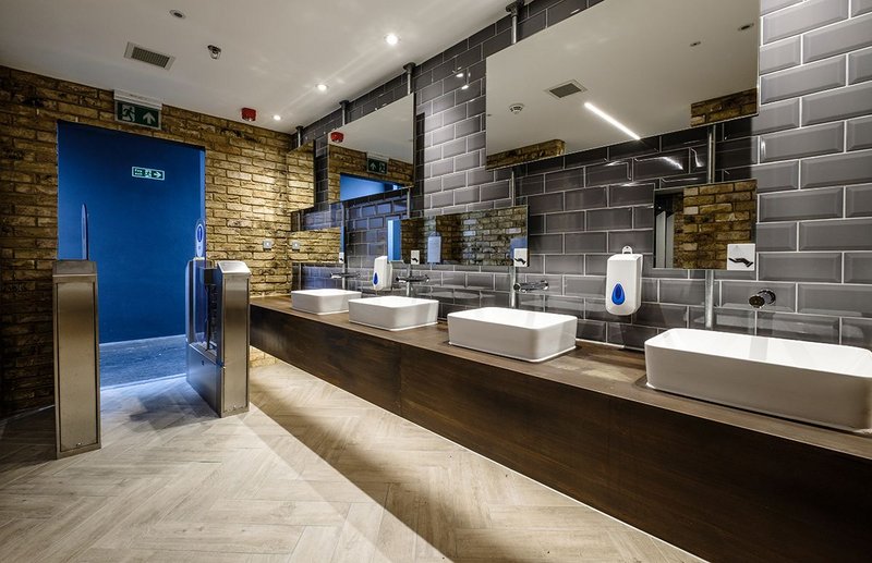 Washroom Washroom's rusted effect mild steel laminate vanity units, metro tiles and exposed brick bring industrial style to Camden Market.