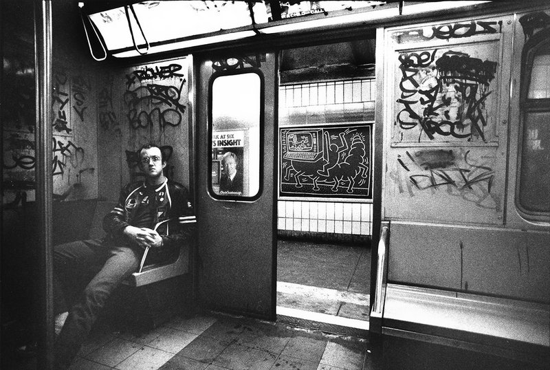 Keith Haring in subway car, (New York), circa 1983.  Tseng Kwong Chi photo © Muna Tseng Dance Projects, Inc. Art © Keith Haring Foundation