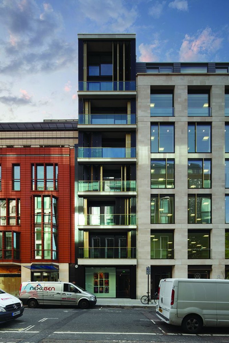 Slice of life: conventional office block to the right, with the slender apartment stack separately expressed.