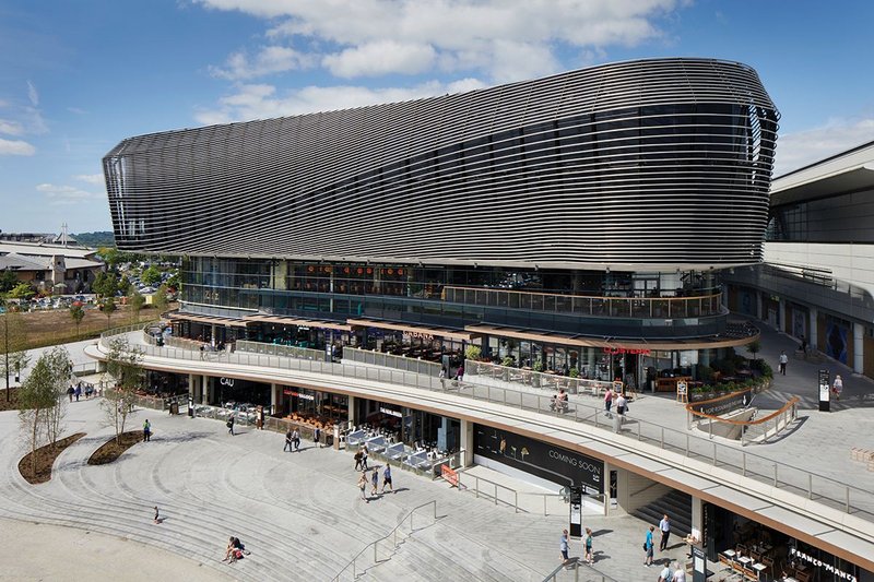 The lower and upper level promenades around a new public auditorium.