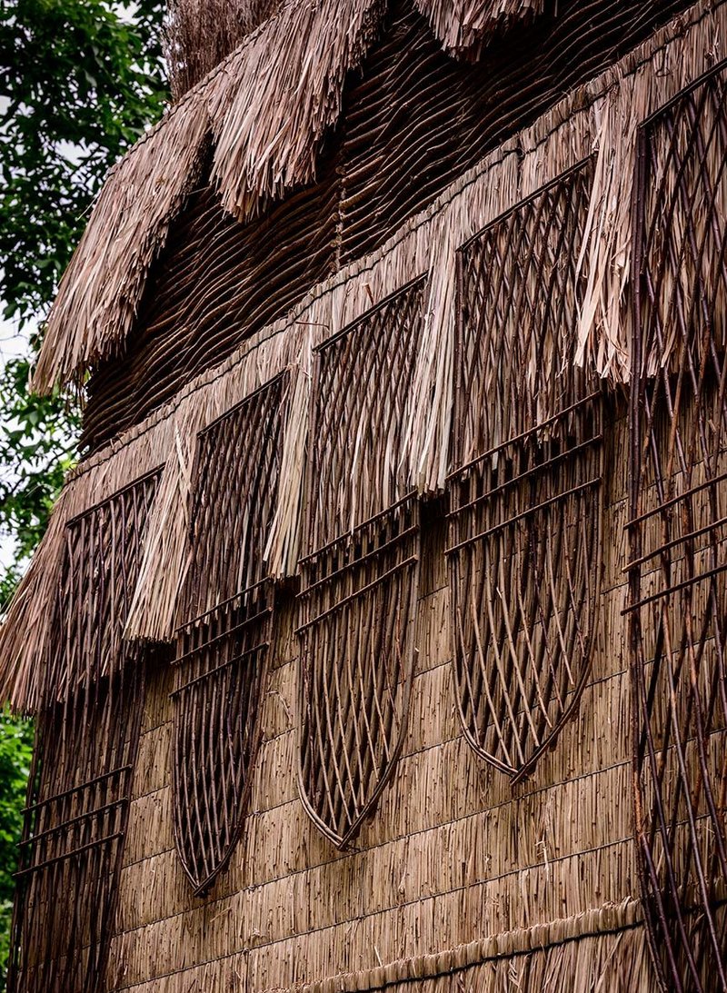 FleaFollyArchitects took inspiration from both Ethiopian and English materials and forms to create the cladding for its False Banana Pavilion using woven hazel, reeds and grass.