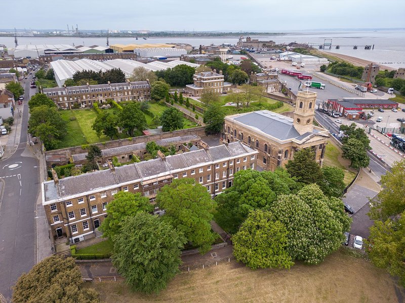 The restored church in context looking north-west, with Georgian naval officer housing alongside and behind, and today’s working commercial port with remaining historic buildings beyond.