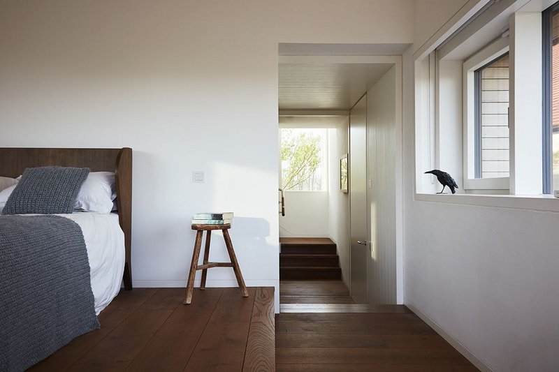 A simply furnished bedroom in one of the four oasts incorporated into Caring Wood.