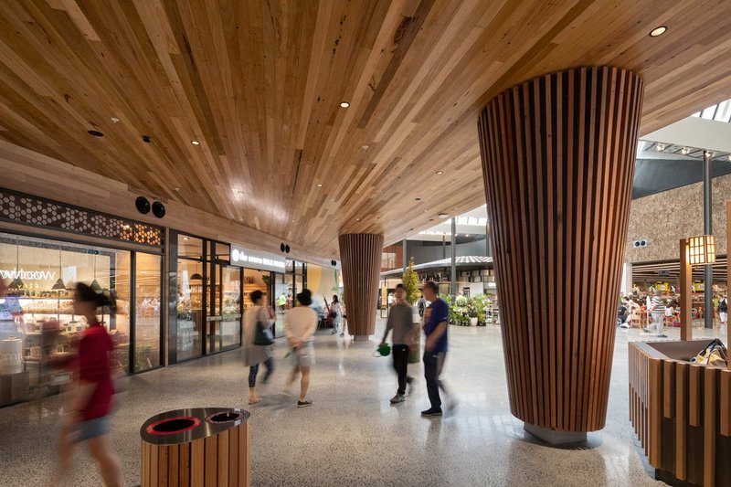 Burwood Brickworks Shopping Centre: an area clad in reclaimed timber, leading to the market hall.