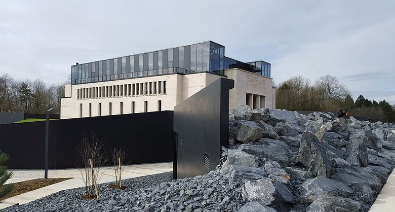 Visitors enter the museum through ‘la rue noire’ – black stone and concrete-lined trenches either side of a new foyer buried beneath the original oak front doors. The rest of the lower ground floor is opened up to extend exhibition space, while a new glazed crown contains a library, multimedia centre, seminar room and temporary exhibition gallery.