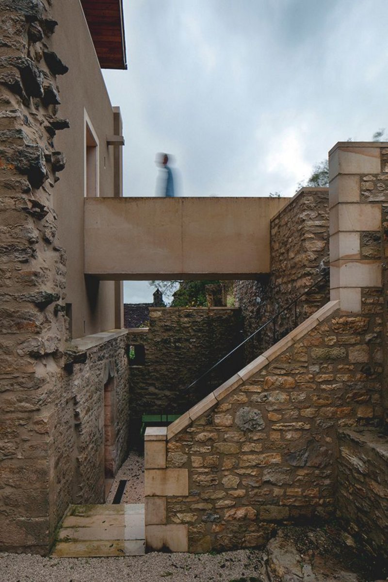 The concrete door frame appears to extrude into the precast concrete bridge.