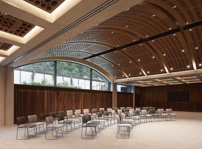 The conference room’s wide, shallow arch strategically admits natural daylight to an otherwise subterranean space.