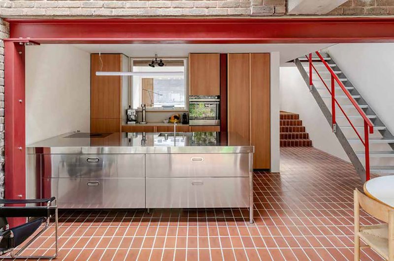 A steel kitchen island combines with Douglas Fir joinery and extensive use of brick.