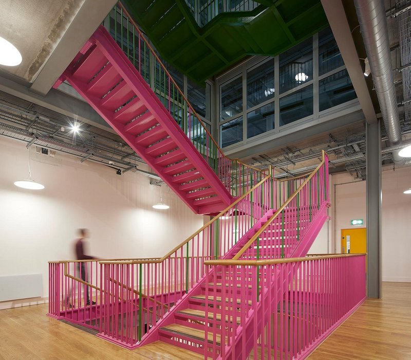 The staircase is teamed with oak flooring in the upper circulation levels. It transitions to green on the two office floors.