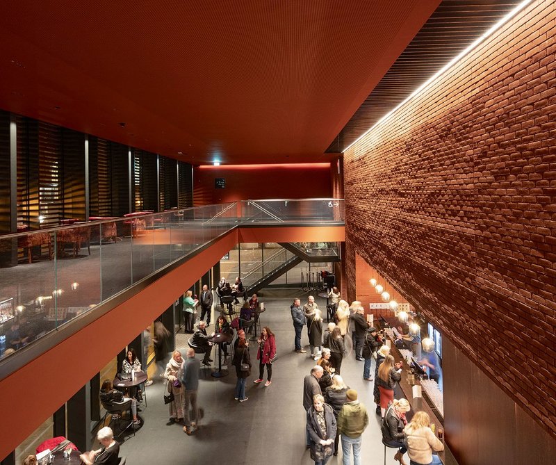 By night the foyer presents a scene of bustle to the public square outside.