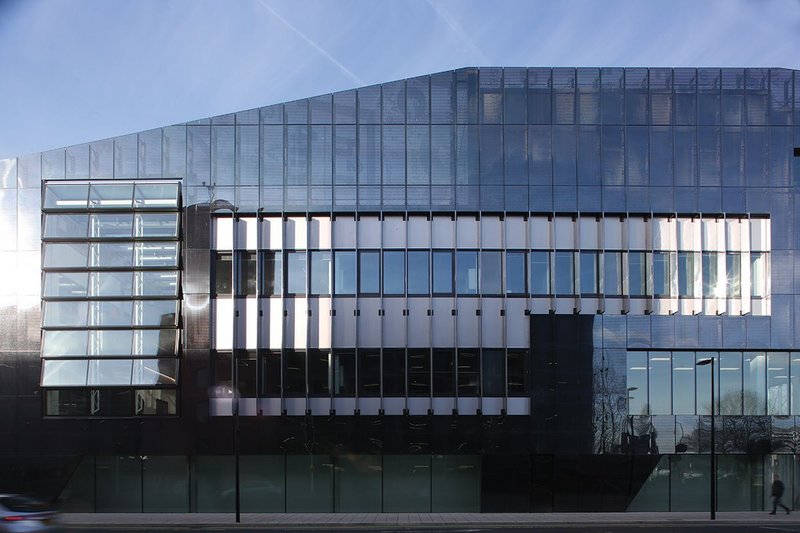 A layered facade incorporates Schueco systems, metallic cladding and a perforated steel veil.