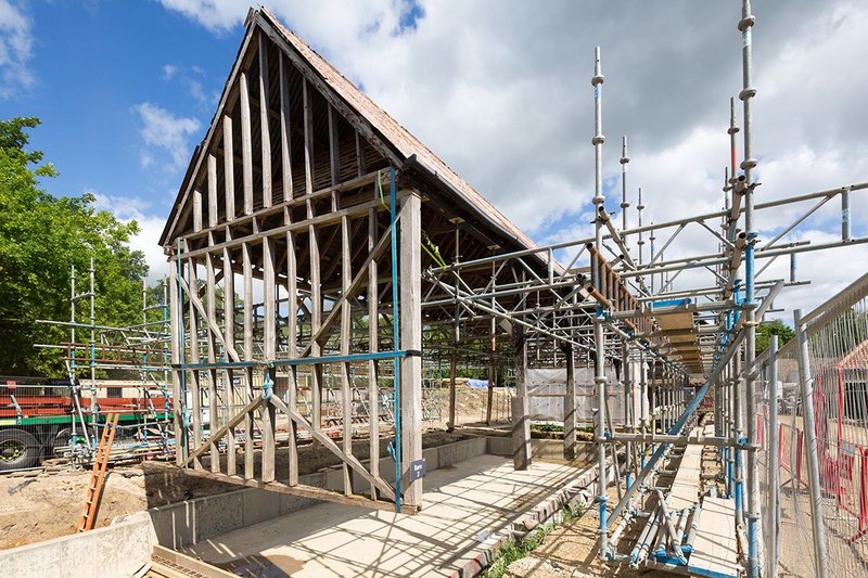 On site with the structure of one of the barns almost suspended.