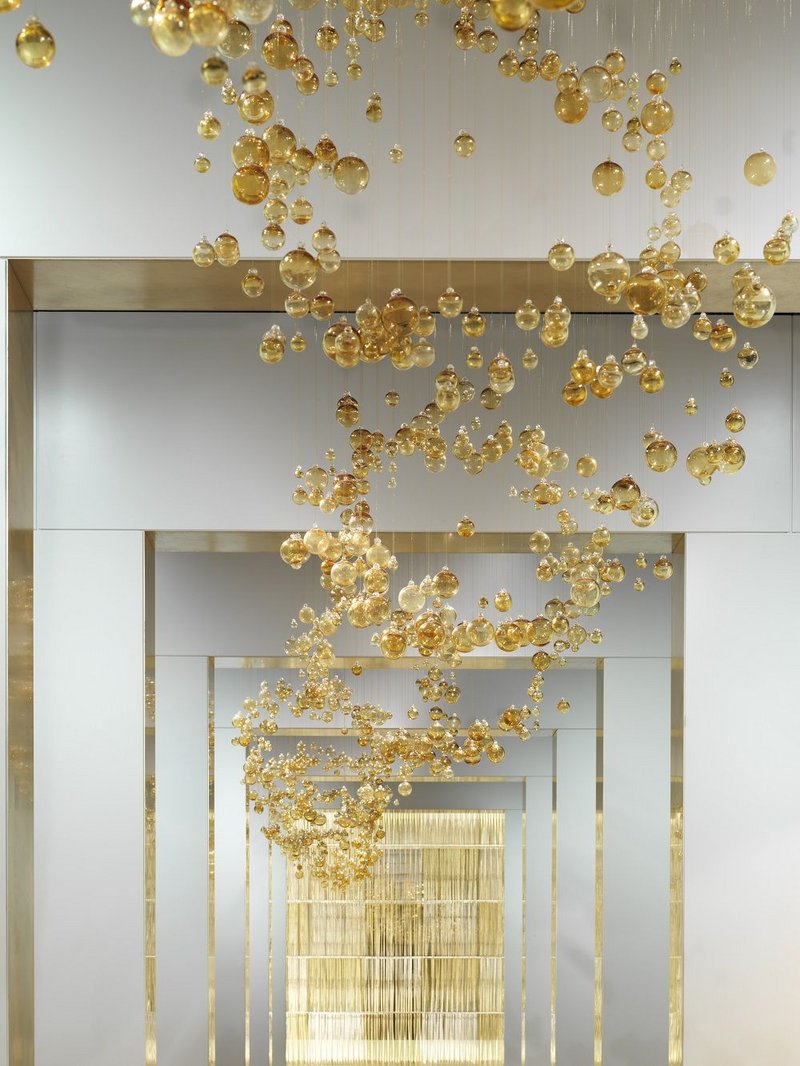 Over 5000 golden baubles have each been hand strung and hung in the art gallery inspired showroom.