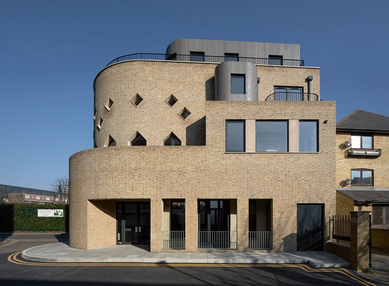 Deep recesses in the base contain a back entrance to the Ivy Street Family Centre and its small outside terrace. The interior is being fitted out by Sarah Wigglesworth Architects.