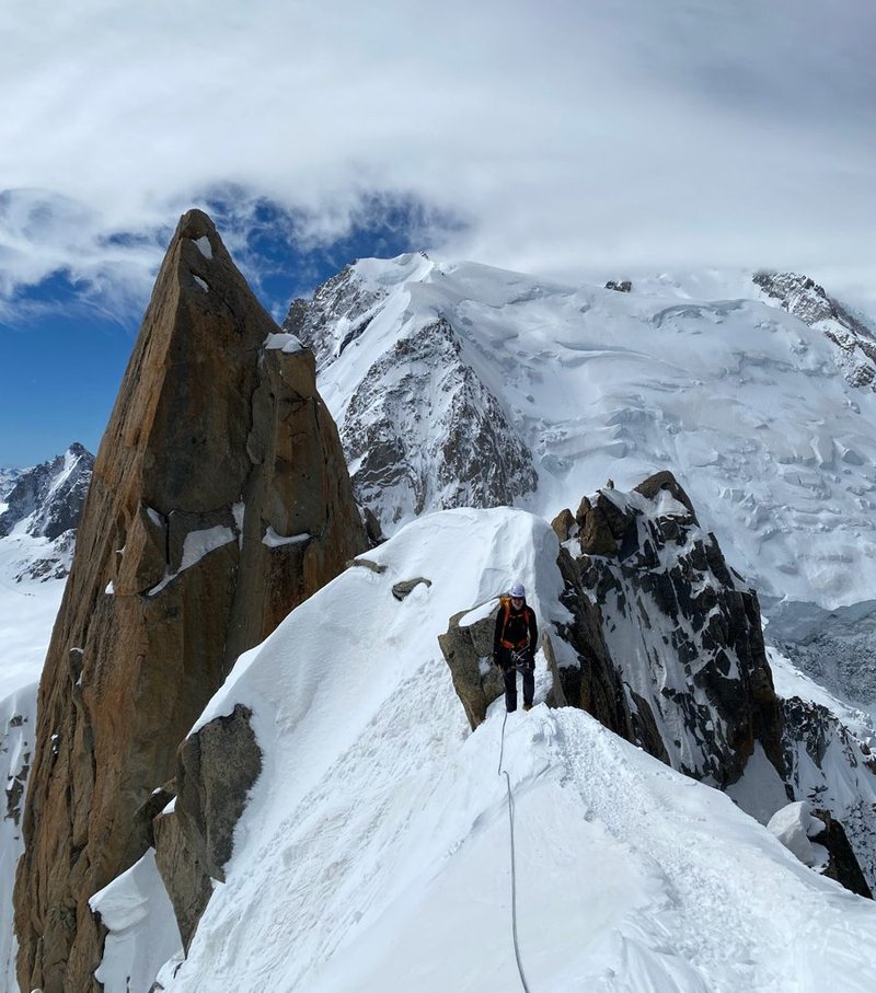 Halfway along The Cosmique Arête with Mont Blanc in the background.