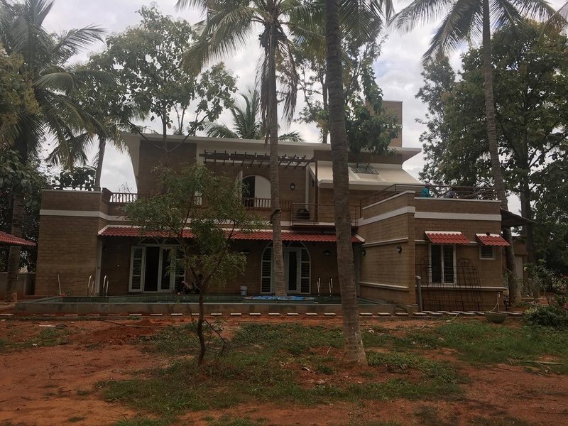 A contemporary sustainable home in Bangaluru, using modern methods of manufacturing and engineered earthen material to create compressed earth bricks.