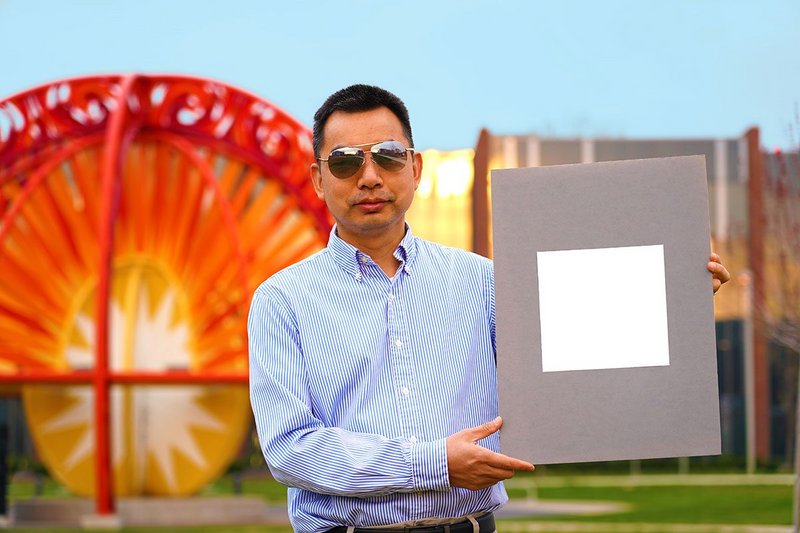 Xiulin Ruan, a Purdue University professor of mechanical engineering, holds up his lab’s sample of the whitest paint on record.