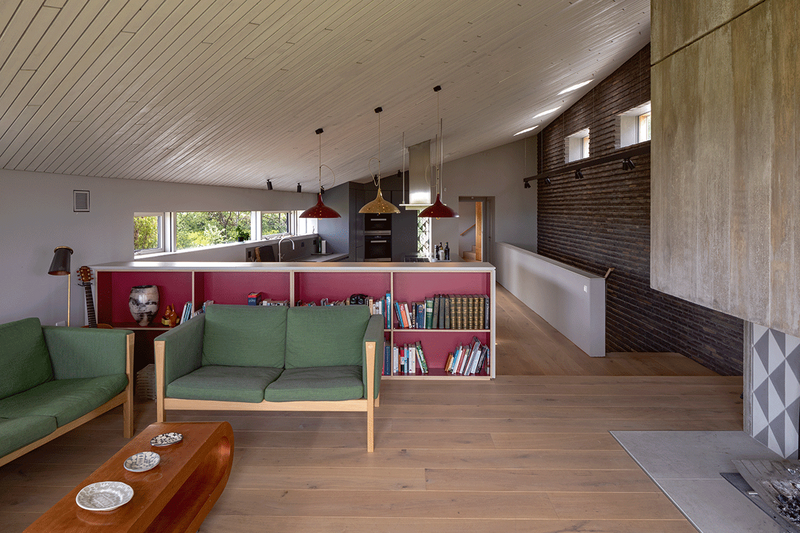 Looking back through the house from the living space, past the kitchen to the master bedroom suite.