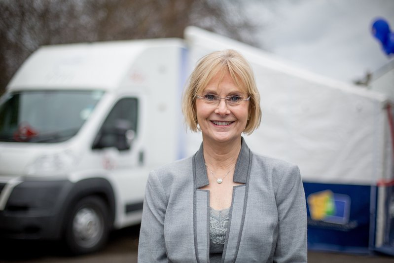 Inventor PK Beville in front of the Virtual Dementia Tour mobile touring Britain.