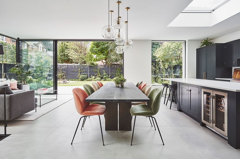 Floor-to-ceilling minimal framed glazing panels bring light and garden into lounging, dining and cooking spaces.