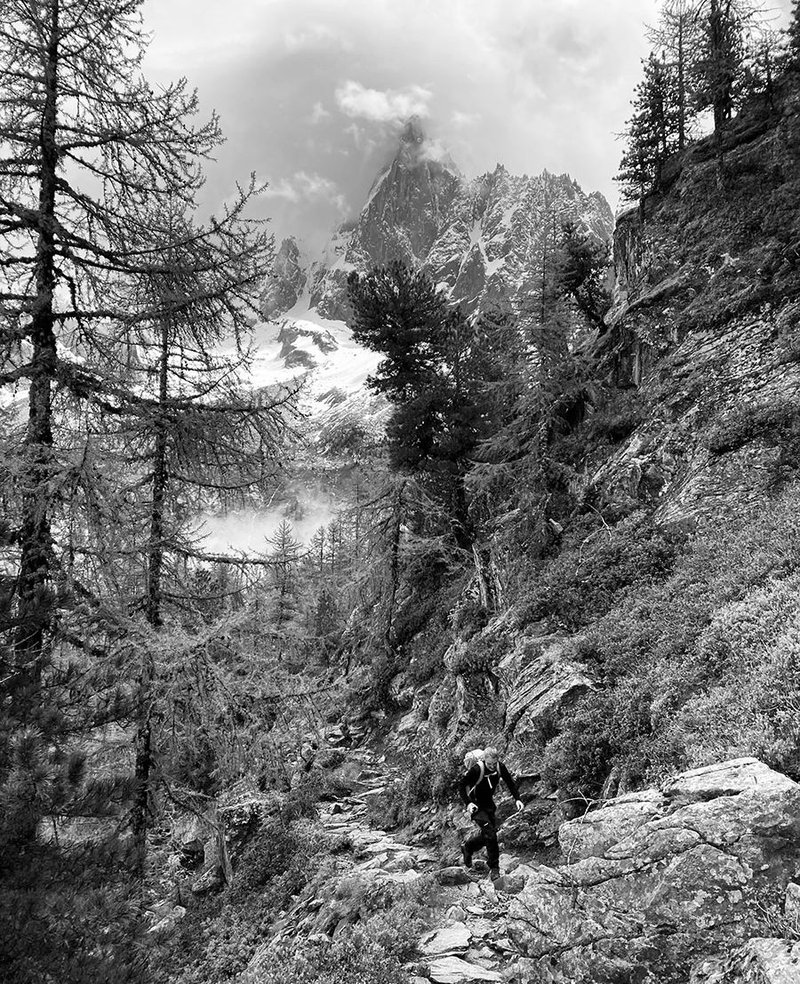 Trekking along the North Balcony with the famous Le Dru in the background.