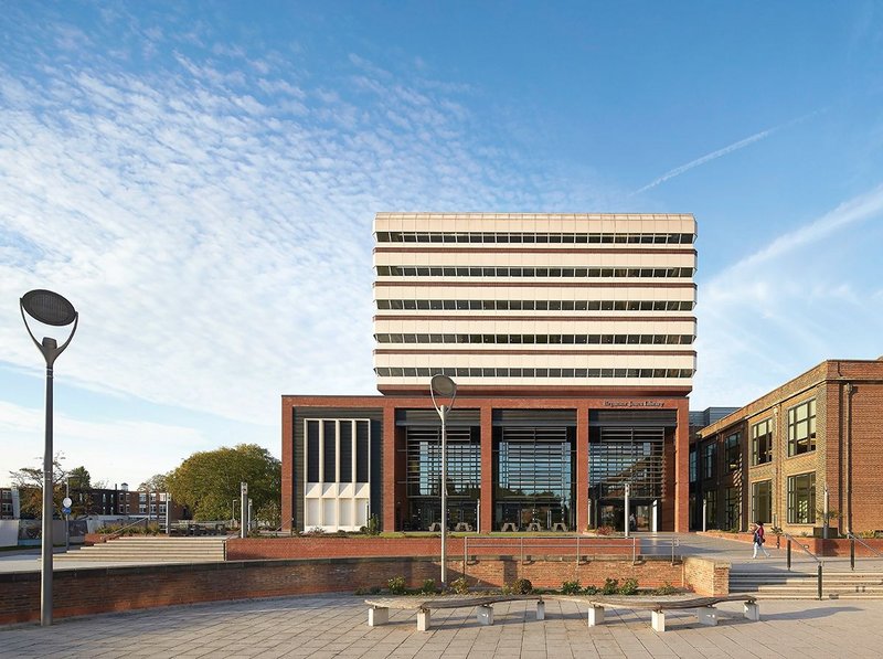 The crinkle-cut 1969 library by  Castle Park Dean Hook rises above its new plinth building by Sheppard Robson.